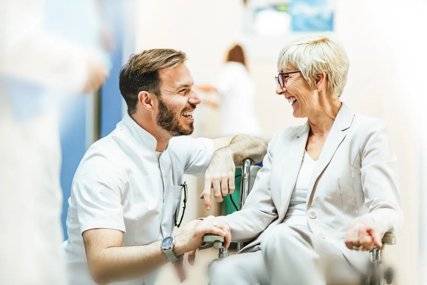 Pfleger und Patientin lachen gemeinsam
